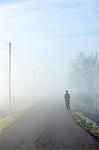 One person running on a hazy road, Sweden.