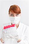 Female scientist in laboratory holding test tubes