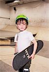 Portrait of boy holding skateboard