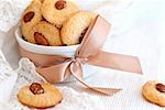 Cookies with almond in the center, dish decorated with ribbon and lace