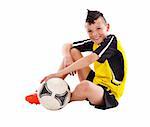 Teenage boy with soccer ball, studio shot