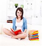 Young girl sitting on the couch and reading books