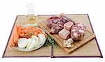 variety of meat, vegetables and white wine for cooking and pot-au-feu on a cooking board