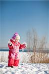 small child playing in winter