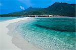 volcanic landscape of camiguin island rises above white beach sand spit mindanao the philippines