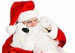 Santa Claus takes telephone call on his land line.  Isolated on white.