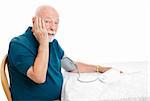 Senior man taking his blood pressure and shocked by the results.  White background.
