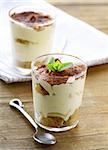 Traditional Italian dessert tiramisu in a glass beaker