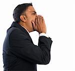 Side view of Asian Indian businessman shouting over white background