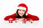 Beautiful asian woman wearing Santa's hat with small christmas gifts, isolated on white