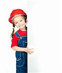 smiling little girl in the construction helmet with a white board