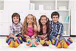 Happy children sitting on the carpet wearing colorful socks