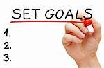 Hand underlining Set Goals with red marker isolated on white.