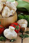 Fresh champignon mushrooms on a wooden table