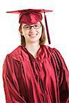 Friendly, smiling high school or college graduate in her cap and gown.  Isolated on white.