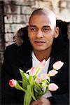 Portrait of Man Outdoors Holding Tulips, Mannheim, Baden-Wurttemberg, Germany