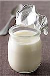 Close-up of Foil Lid opened on Single Serving Yoghurt on Grey Background, Studio Shot