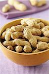 Close-up of Bowl of Peanuts on Purple Background, Studio Shot