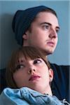 Close-up Portrait of Young Couple Absorbed in Thought, Studio Shot on Blue Background