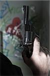 Close-up of Man holding Gun with Graffiti in Background, Mannheim, Baden-Wurttemberg, Germany