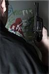 Close-up of Man holding Gun with Graffiti in Background, Mannheim, Baden-Wurttemberg, Germany