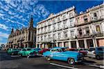 Classic Cars Driving by Great Theatre of Havana and Hotel Inglaterra, Havana, Cuba