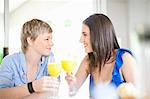 Lesbian couple having orange juice