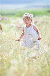 Girl walking in tall grass