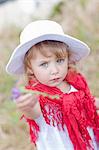 Girl holding flower in field