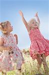 Girls playing in tall grass