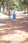 Toddlers playing on dirt road