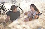 Woman playing guitar for boyfriend