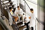 Doctors talking on steps in hospital