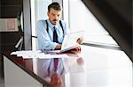 Businessman reading at desk