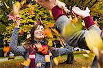 Couple playing in autumn leaves