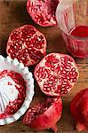 Halved pomegranates with juice