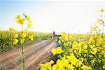 Mother and daughter walking on dirt road