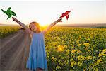 Girl playing with pinwheels outdoors