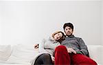 Couple relaxing on sofa together