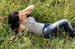 Woman laying in tall grass