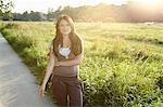 Woman standing on rural road