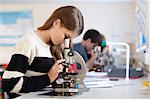 Student using microscope in class