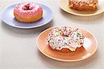 Doughnuts with colourful glaze and sugar sprinkles