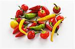 Various type of peppers on a white surface