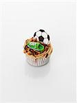 A caramel cupcake decorated with football motifs