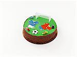 A birthday cake decorated with football motifs