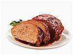 Partially Sliced Meatloaf on a Plate; White Background