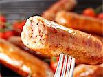 A Cumberland sausage on a fork (close-up)