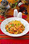 A plate of nasi goreng on a red placemat