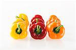 Rows of red, yellow and orange peppers arrange by colour